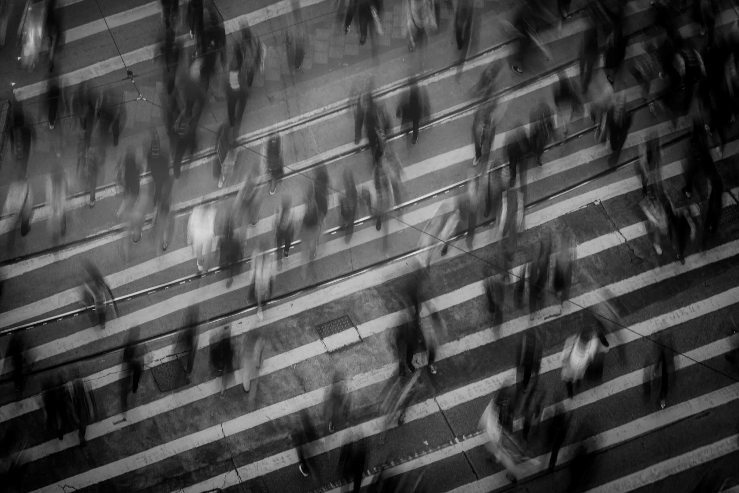 potential audience members walk on a busy street